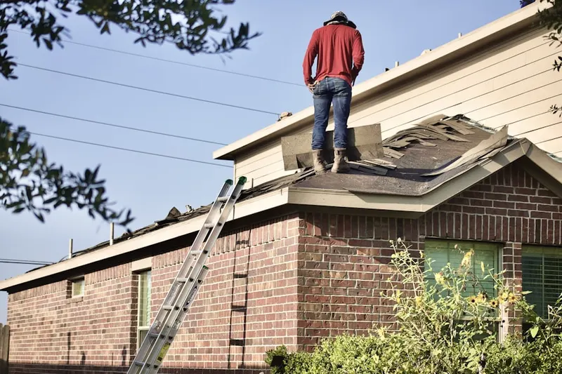 Professional roofer working on a residential roof in North Lindenhurst